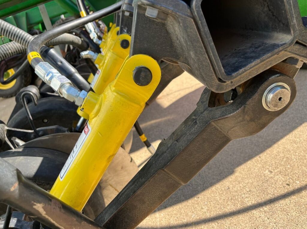 Up close view of a UniForce cylinder on a John Deere drill.